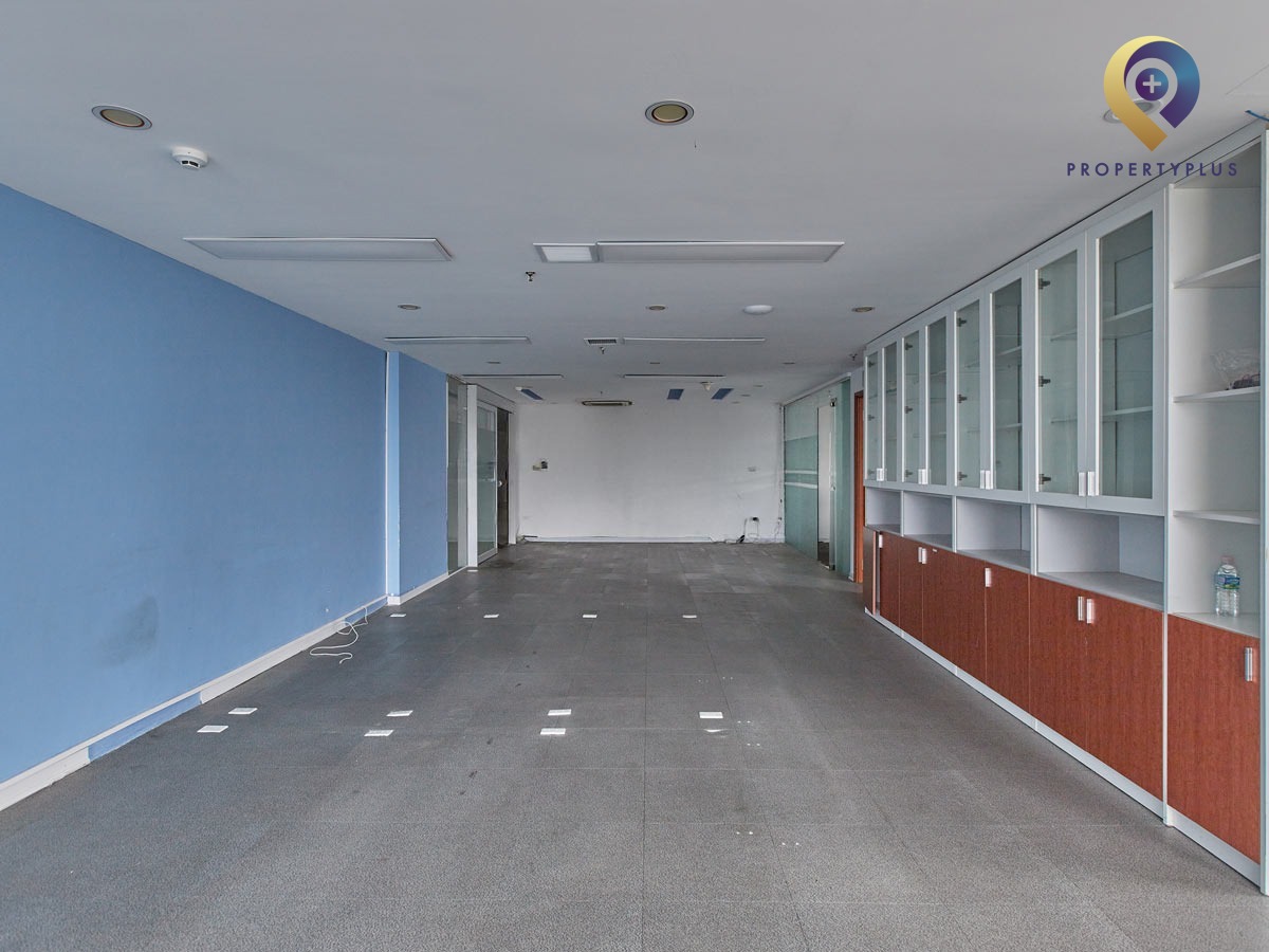 Vacant office space with large windows and natural light at Sudico Tower